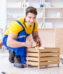 Repairman carpenter working with wooden board plank and measurin