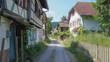 A peaceful village street lined with quaint traditional European houses and the tranquility of a rural setting