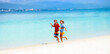 © famveldman - Kids playing on beach. Children play at sea.
