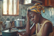 a african young mother is crying at the stove being tired of housework