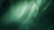 A simple, dark, and blurry green abstract background with a gradient blur effect, ideal for studio lighting designs
