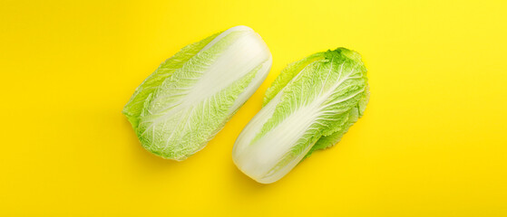 Fresh ripe Chinese cabbages on yellow background, top view. Banner design