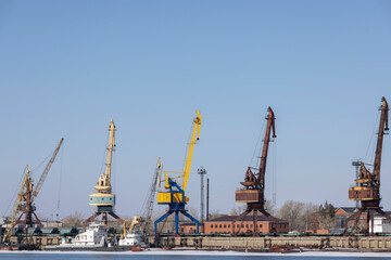 huge river loading cranes. on the river bank in winter
