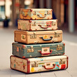 A stack of vintage suitcases with travel stickers.