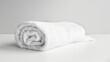 rolled up white beach towel on white background
