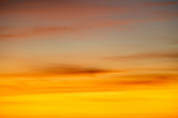 Wall Mural - The dramatic colors of the sunset in the sky gradient from blue to orange.