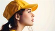 © Irina Ukrainets - Profile of a young woman wearing a yellow cap against a light background, showcasing style and simplicity. Portrait with a contemporary casual look. AI