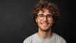 Smiling Man With Curly Hair and Glasses