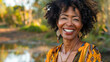 Black american woman in her 50s who exudes happiness and a sense of feeling truly alive in a beautiful natural park near a lake, genuine smile on her face, relaxed and confident, female who found joy