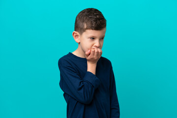 Wall Mural - Little kid boy isolated on blue background having doubts