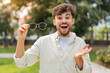 © luismolinero - Young Arabian handsome man with glasses at outdoors with shocked facial expression