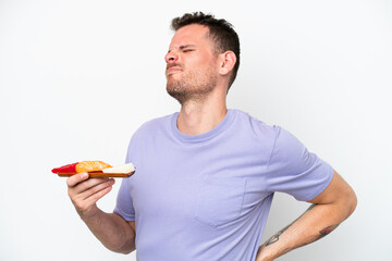 Wall Mural - Young caucasian man holding sashimi isolated on white background suffering from backache for having made an effort