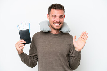 Wall Mural - Young caucasian man holding a passport isolated on white background saluting with hand with happy expression