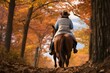 Couple enjoying a romantic horseback ride through a scenic autumn trail