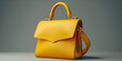 Beautiful trendy smooth youth women's handbag in bright yellow color on a gray studio background. generative ai 