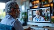 Senior doctor engaging in a telemedicine session with professional colleagues on a computer discussing patient care strategies.