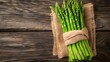 Close up of a fresh Asparagus Bundle on a rustic wooden Table