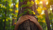 Nature lover hugging trunk tree with green musk in tropical woods forest. Green natural background. Concept of people love nature and protect from deforestation or pollution or climate change.