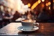 Cappuccino in a white cup on a wooden table with a blurred background of a busy cafe