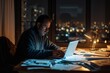 Man working late on laptop in home office with city lights in the background