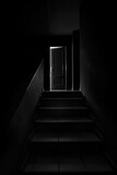Fototapeta Młodzieżowe - Black and white image of a dark staircase with a door ajar at the end, like a scene from a horror movie