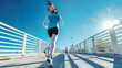 © esp2k - A woman runs on a bridge with the sun shining on her