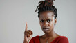 Angry Black Woman Making A Disapproving Gesture With Her Finger. Conveying a Sense of Disagreement or Refusal