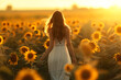 young woman in a white dress walking through a sunflowe 0e998656-50e0-4103-97b9-32299c69f7a4