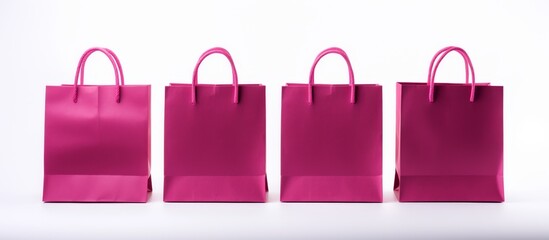 Poster - Four pink shopping bags are arranged in a row on a white surface, showcasing a trendy fashion accessory with a vibrant violet, magenta, and electric blue pattern