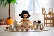 A small toy doll is an Asian woman with black hair, sitting at a table and arranging a tea party, toy cups and mugs around. With different toy animals at the table.