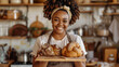 A black woman holding breads in her hands, she is smiling and wearing an apron, the background of the kitchen with shelves full of baking tools and decorations, professional photography, beautiful lig