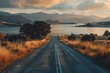 Empty road leading to the lake by sunset, adventure-themed landscape vistas