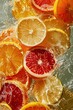Mix of citrus fruit pieces swooping by in water,