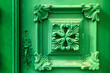 ornate detail of a wooden door painted in green