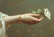 Woman's arm holding a flower in her hand, classical design environment, pale colors