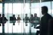 Defocused Important management meeting behind glass wall
