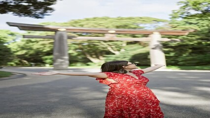 Poster - Joyful hispanic woman smiling with open arms, looking around at meiji temple, showcasing confidence and happiness