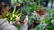 © Prostock-studio - Woman Taking Picture of Plants in Greenhouse