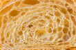 © alexanderon - Macro shot of fresh croissant cut in a half. Baked croissant dough textured background