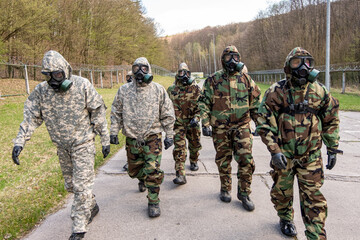 A group of men in military gear are walking down a path