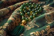 Green prayer beads laid on a patterned fabric, suggesting a spiritual or religious context.