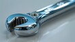 Highlighting the polished chrome surface and ergonomic design of a socket wrench, poised for precise mechanical adjustments.