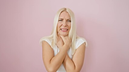 Canvas Print - Distraught blonde woman struggling to breathe, strangle-induced pain and asphyxiation over pink isolated background