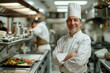 © Formoney - A chef is standing in a kitchen with a smile on his face