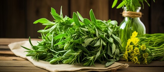 Wall Mural - There is an assortment of plantbased ingredients such as herbs and vegetables on the table, including leaf vegetables, flowers, and grasses