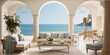 Experience the beauty of coastal living in a Mediterranean-inspired living room featuring elegant archway windows overlooking the azure waters, harmonizing perfectly with the intricate mosaic tiles.