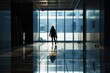 © Igor - Silhouette of employee walking in office lobby
