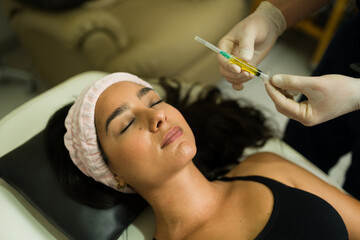 Wall Mural - Top view of an attractive woman getting plasma PRP therapy