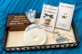 Fototapeta Uliczki - An urn with ashes, paw prints, dog tags with the pet's name, and a lock of the pet's fur, all honoring a loved cat after it's death and cremation.