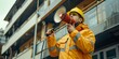 Fireman uses megaphone to announce emergency evacuation in a building, urging occupants to escape to safety. Concept Emergency Announcement, Fire Drill, Building Evacuation, Megaphone Usage